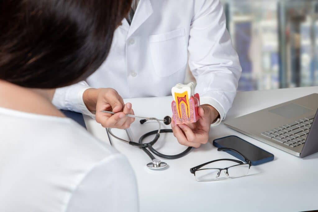 Dentist having a consultation with a patient about the benefits of a root canal vs. an extraction